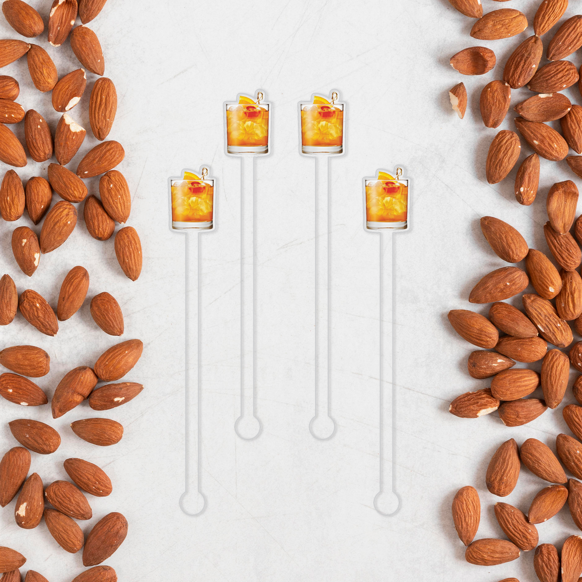Amaretto Sour swizzle stick set in styled cocktail drink on home bar or entertaining setup.