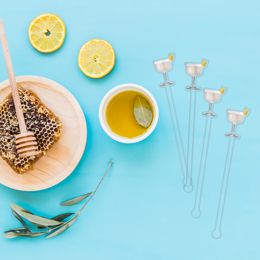 Bee's Knees swizzle stick set in styled cocktail drink on home bar or entertaining setup.