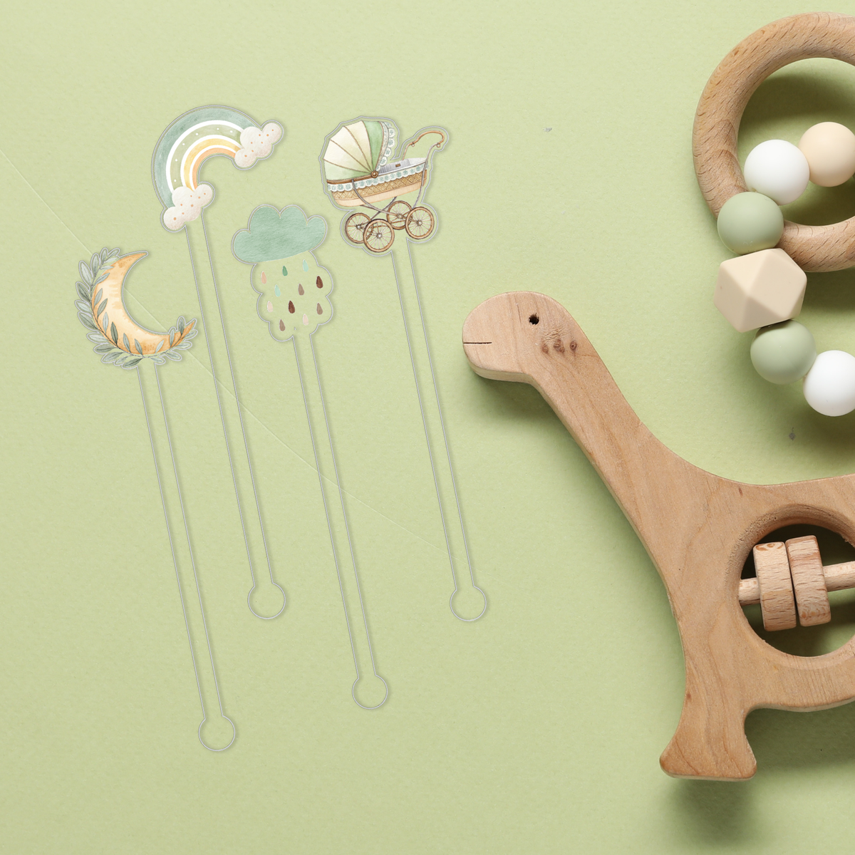 Here We Grow Again swizzle stick set styled for a baby shower celebration