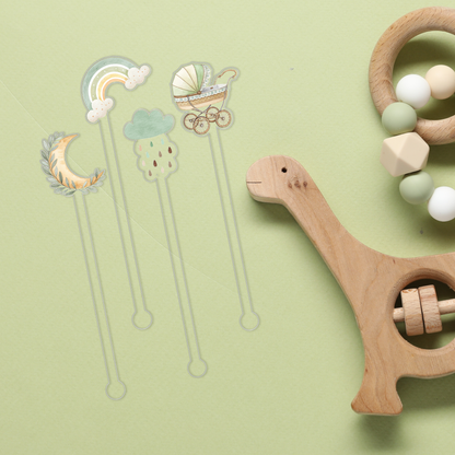 Here We Grow Again swizzle stick set styled for a baby shower celebration