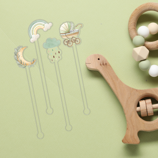 Here We Grow Again swizzle stick set styled for a baby shower celebration