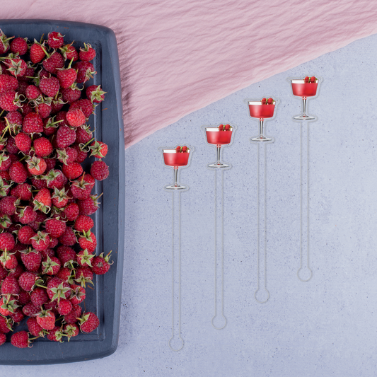 Raspberry Ginger Gimlet swizzle stick set in styled cocktail drink on home bar or entertaining setup.